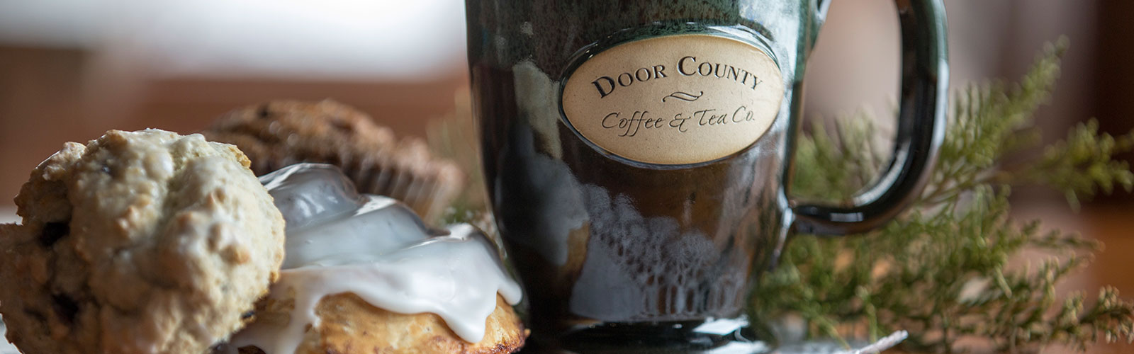 Door County Coffee mug next to some desserts